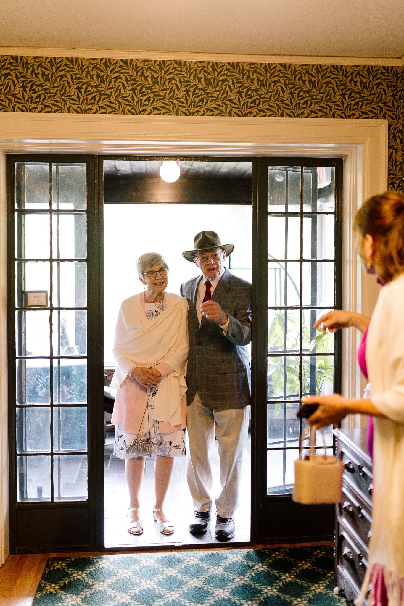 A man and a woman are standing in a doorway.