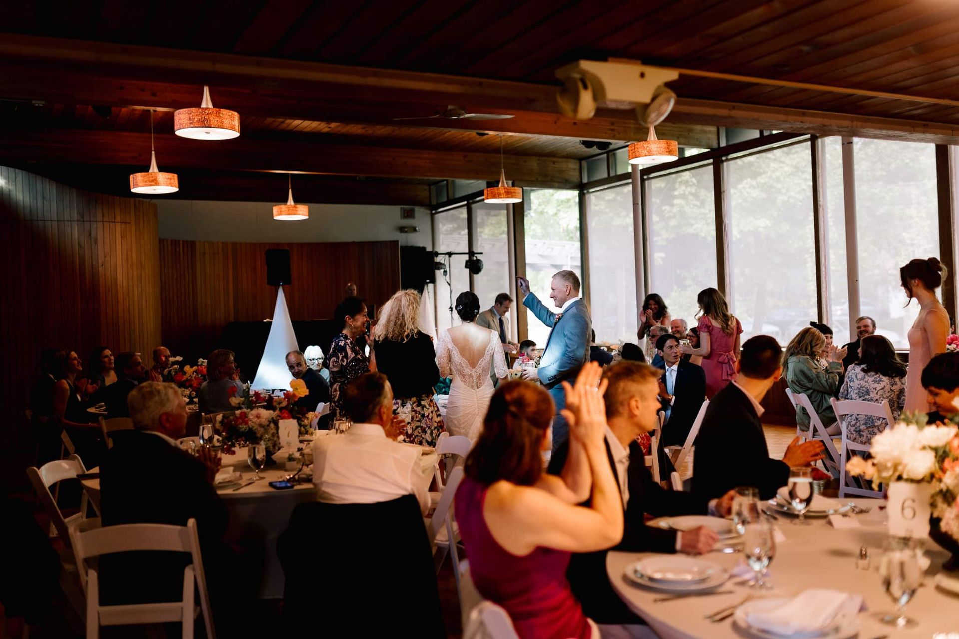 A group of people are sitting at tables at a wedding reception.