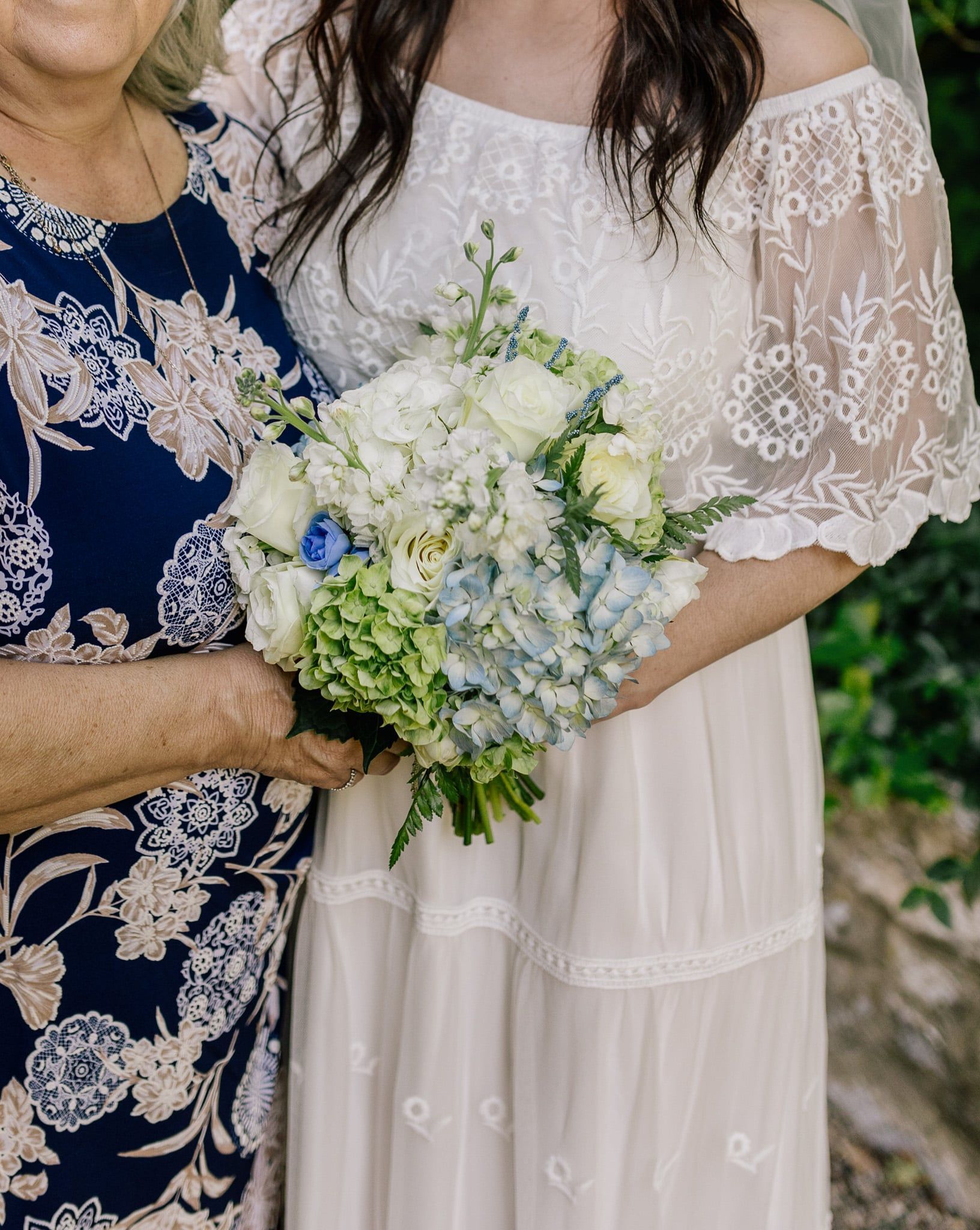 A woman in a white dress is holding a bouquet of flowers.