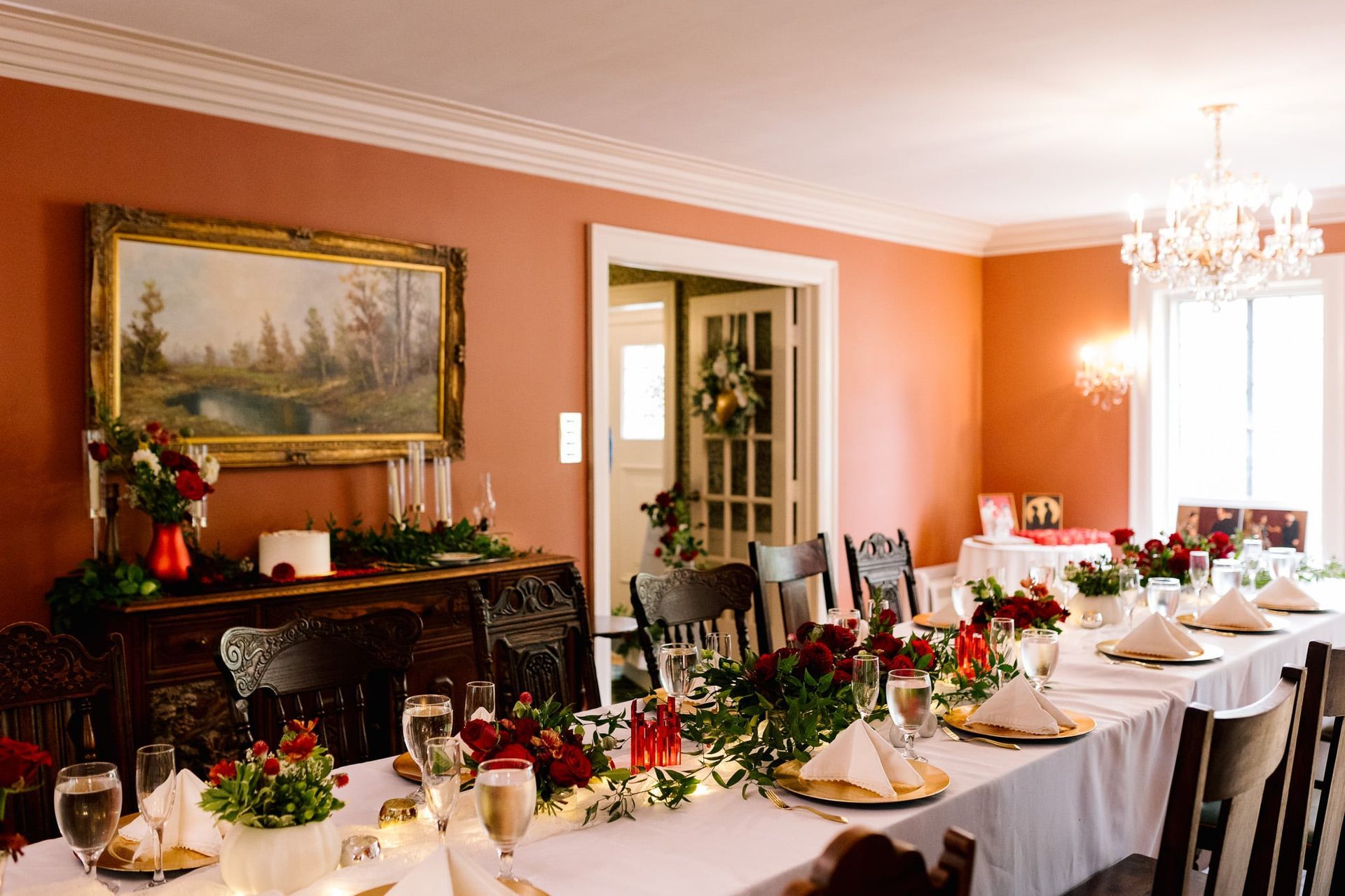 A long table is set for a dinner party in a dining room.