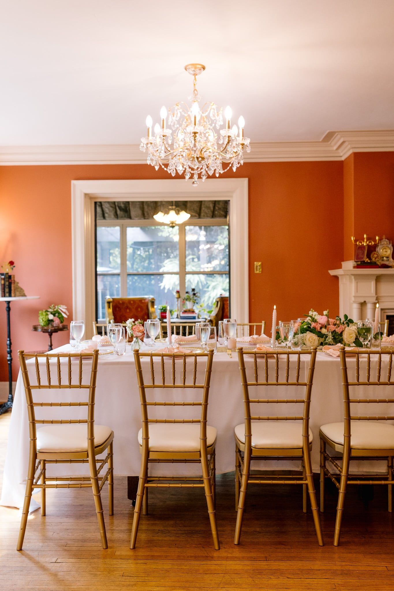 A long table with chairs and a chandelier in a room.