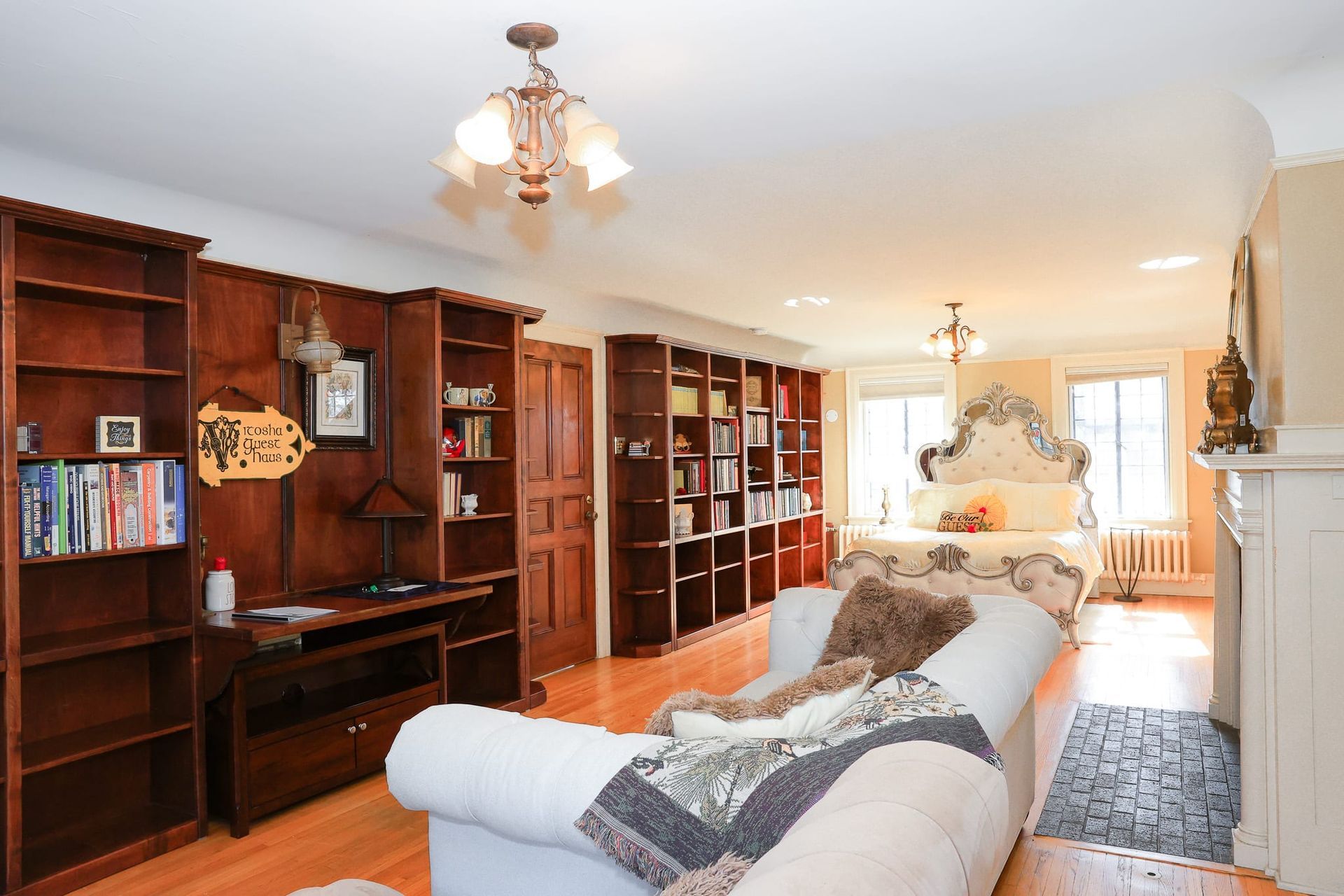 A living room with a white couch and a fireplace