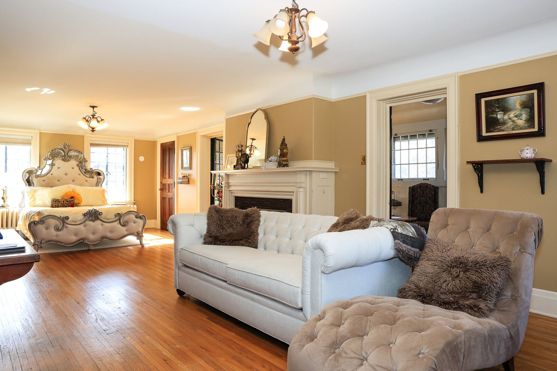 A living room with a couch a chair and a fireplace