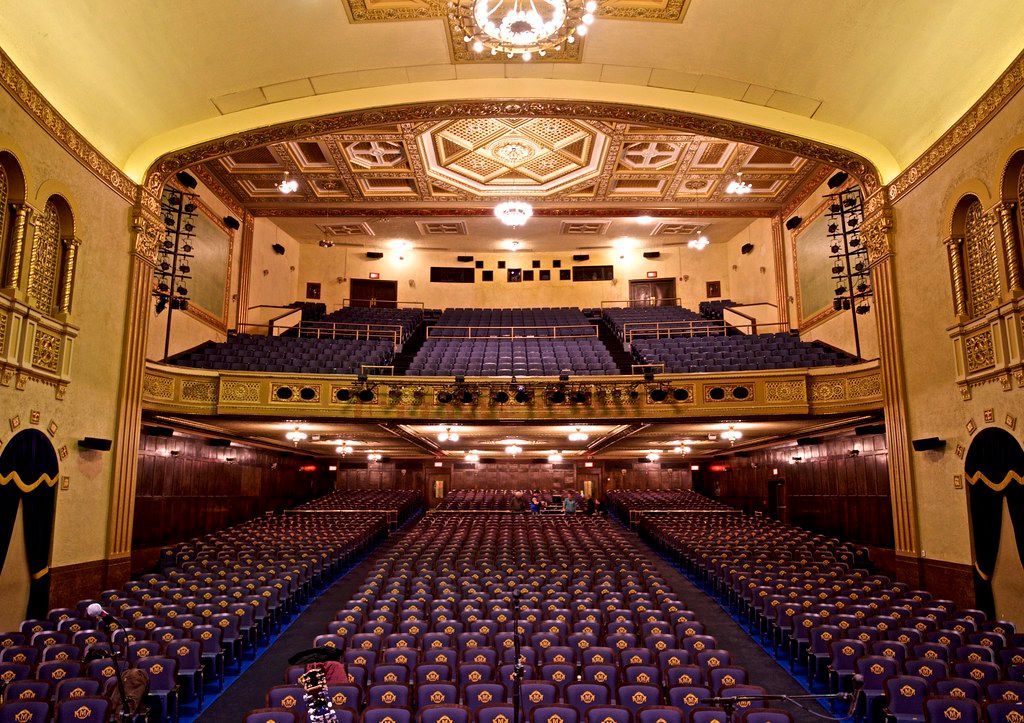 A large auditorium filled with rows of purple seats