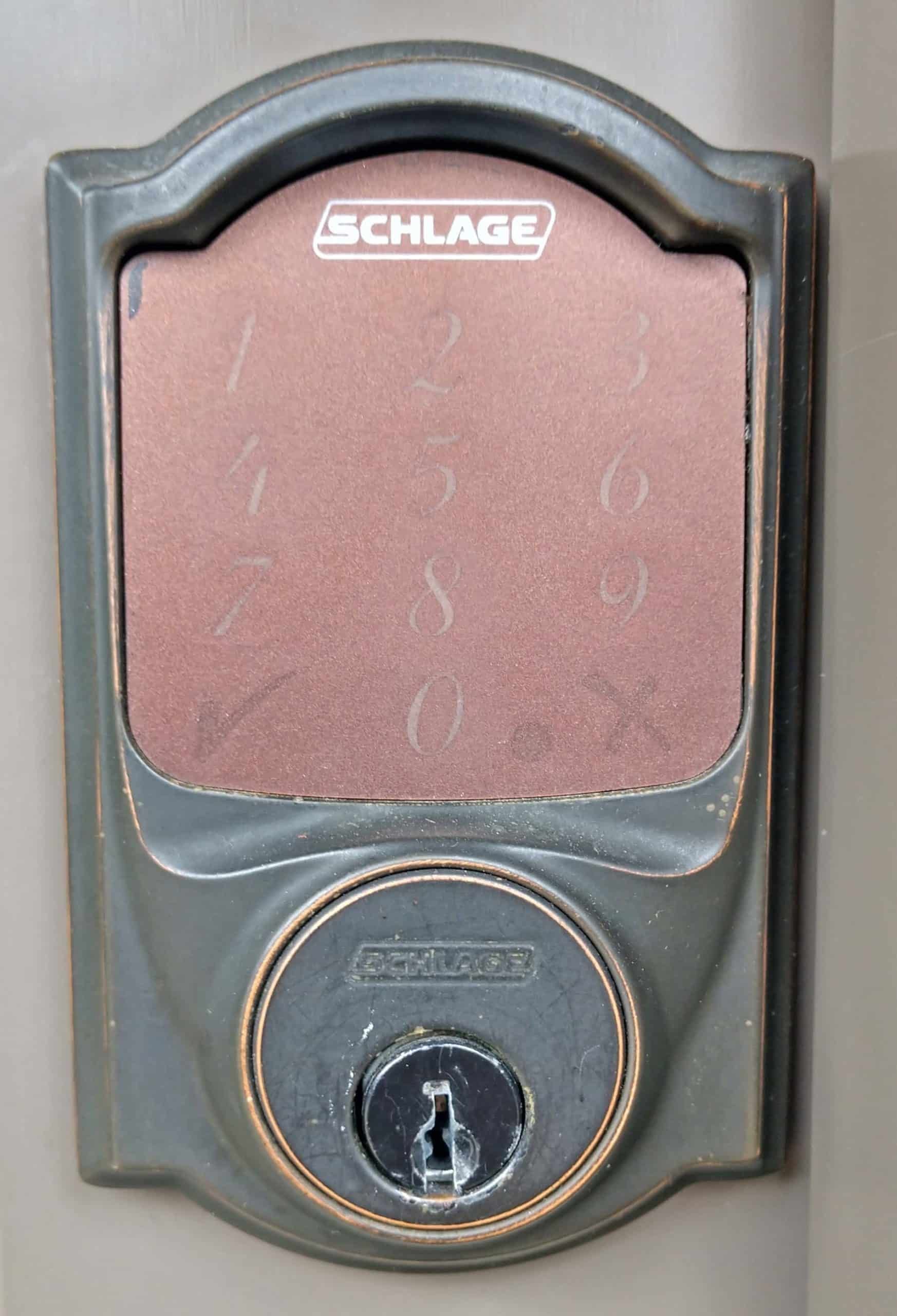 A close up of a schlage door lock