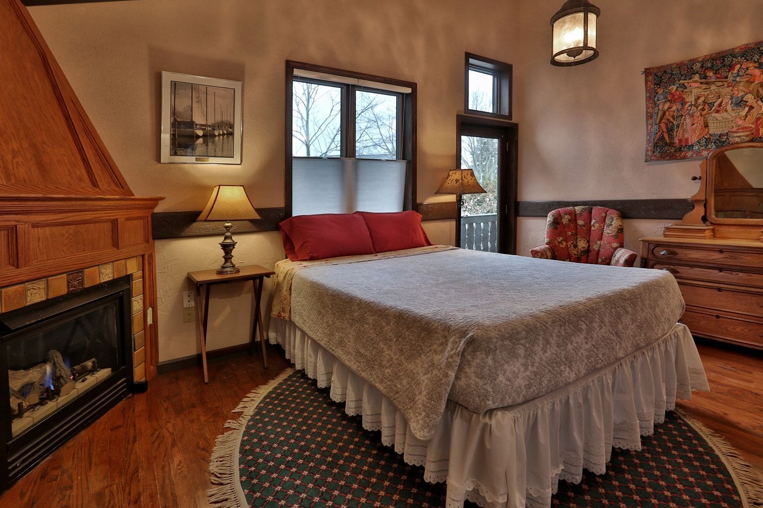 A bedroom with a king size bed and a fireplace