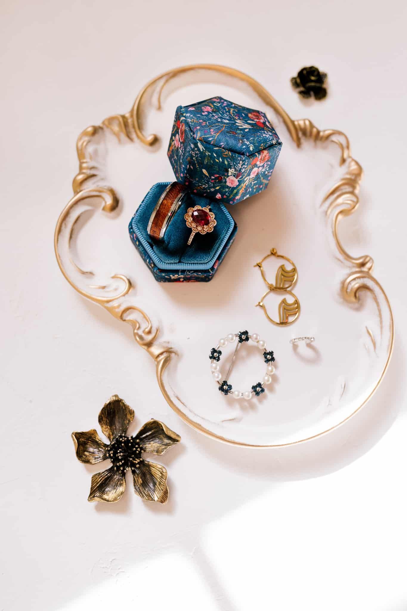 A close up of a necklace , earrings , and a brooch on a table.