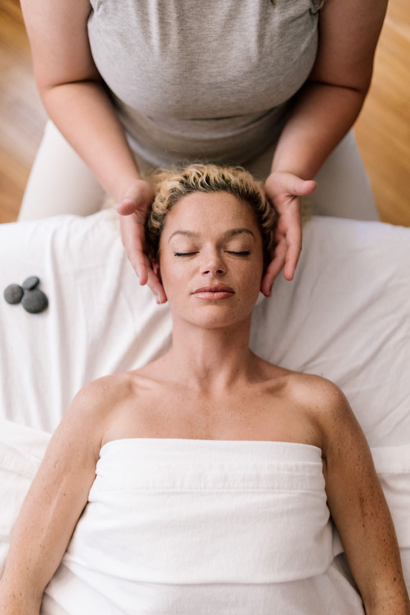 A woman is laying on a table getting a massage.