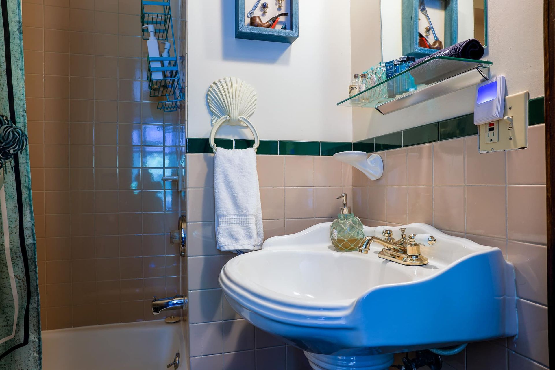 A bathroom with a sink and a shower.