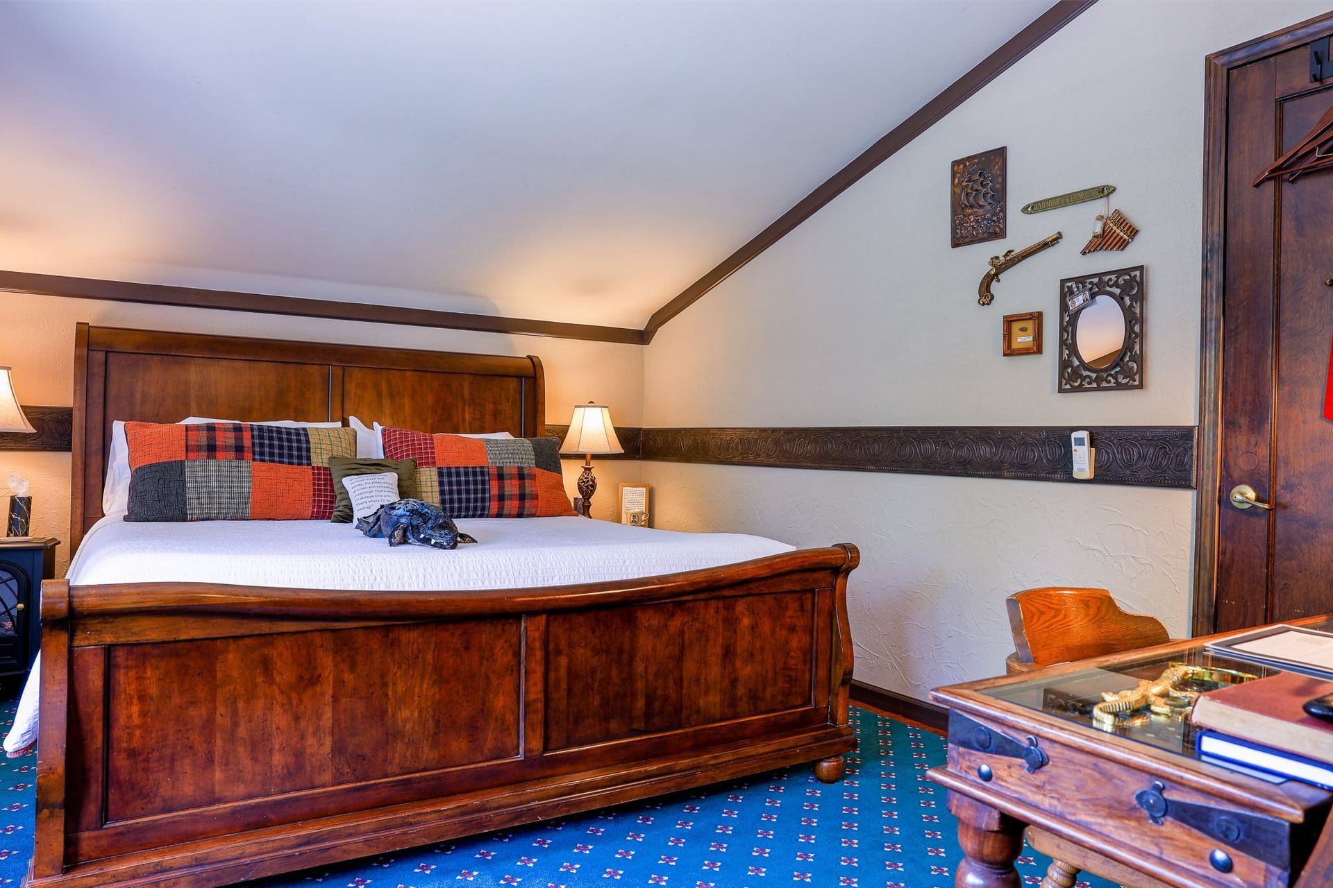 A bedroom with a king size bed and a desk