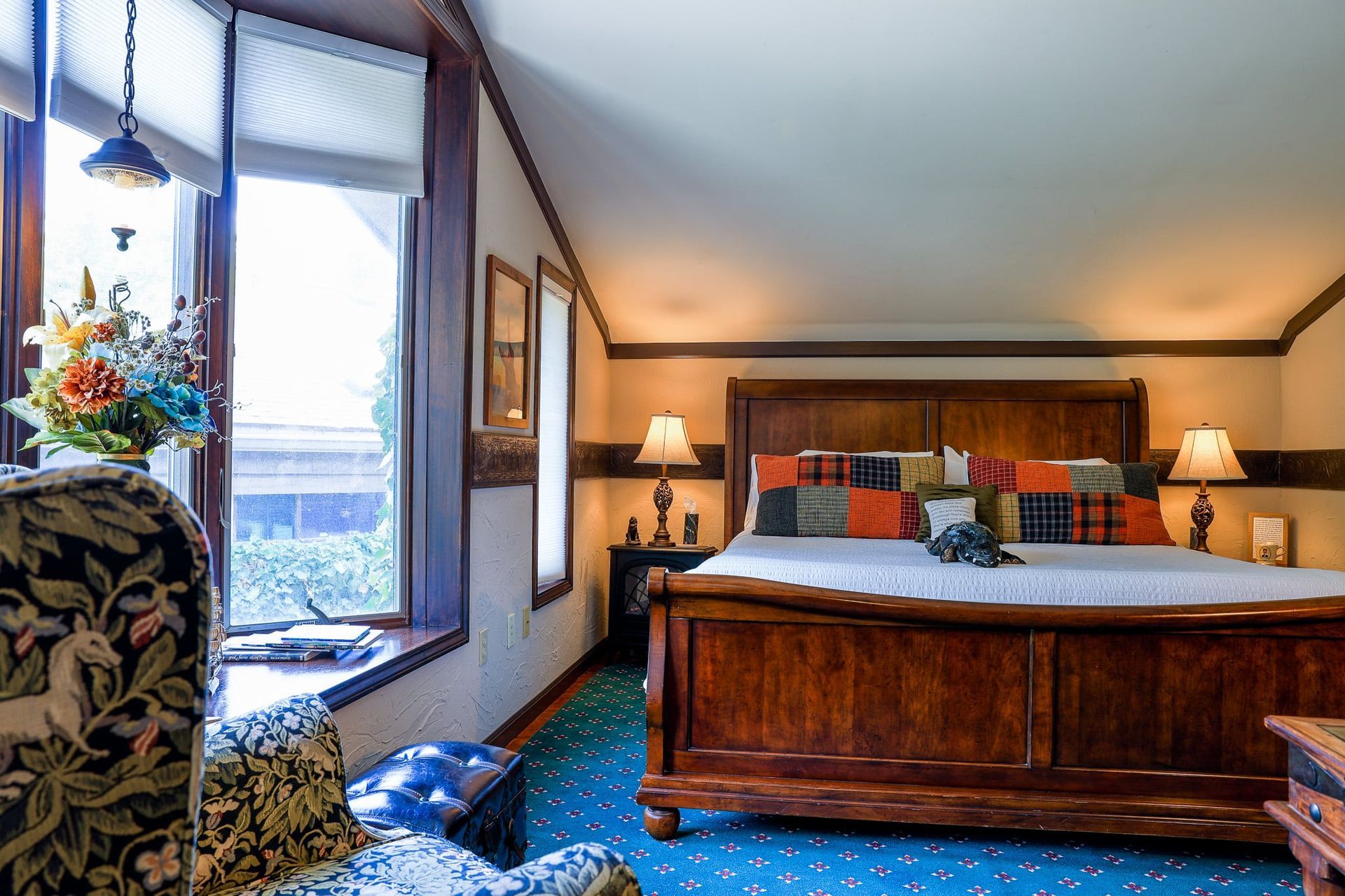 A bedroom with a king size bed and a chair