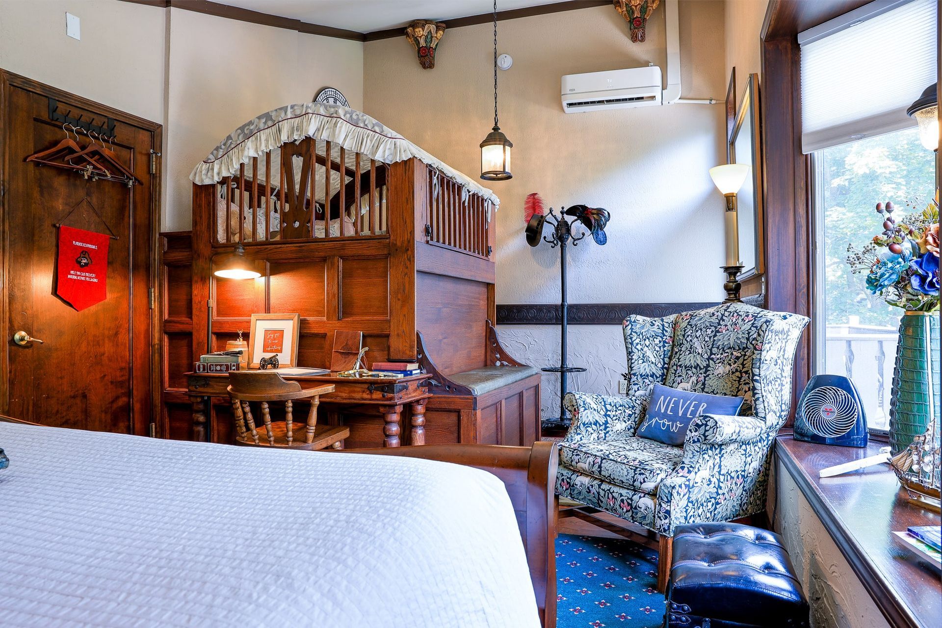 A bedroom with a bed , chair , desk and window