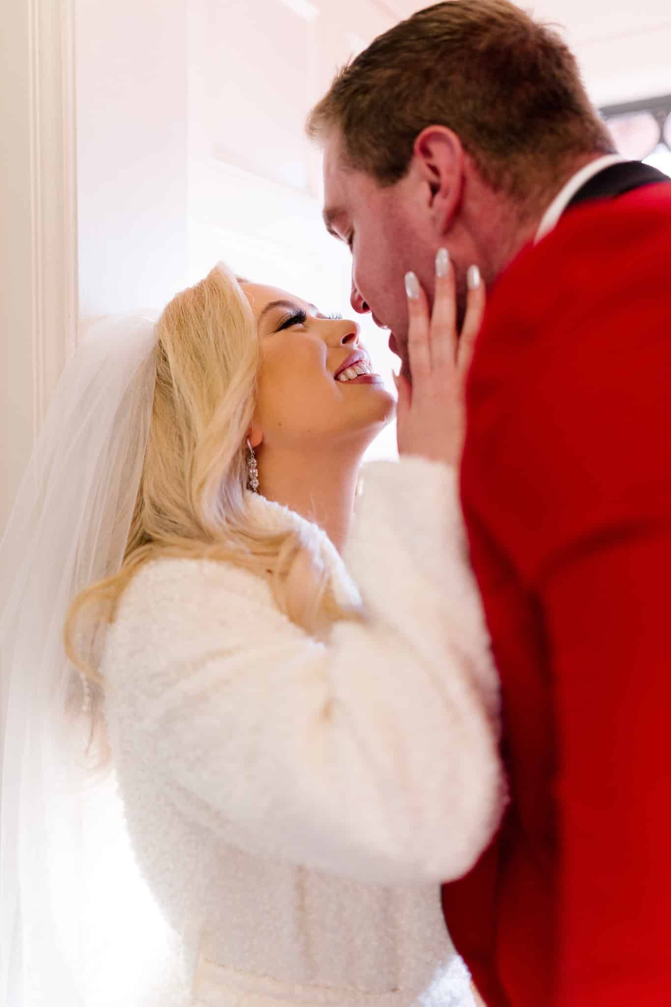 A bride and groom are kissing each other on their wedding day.
