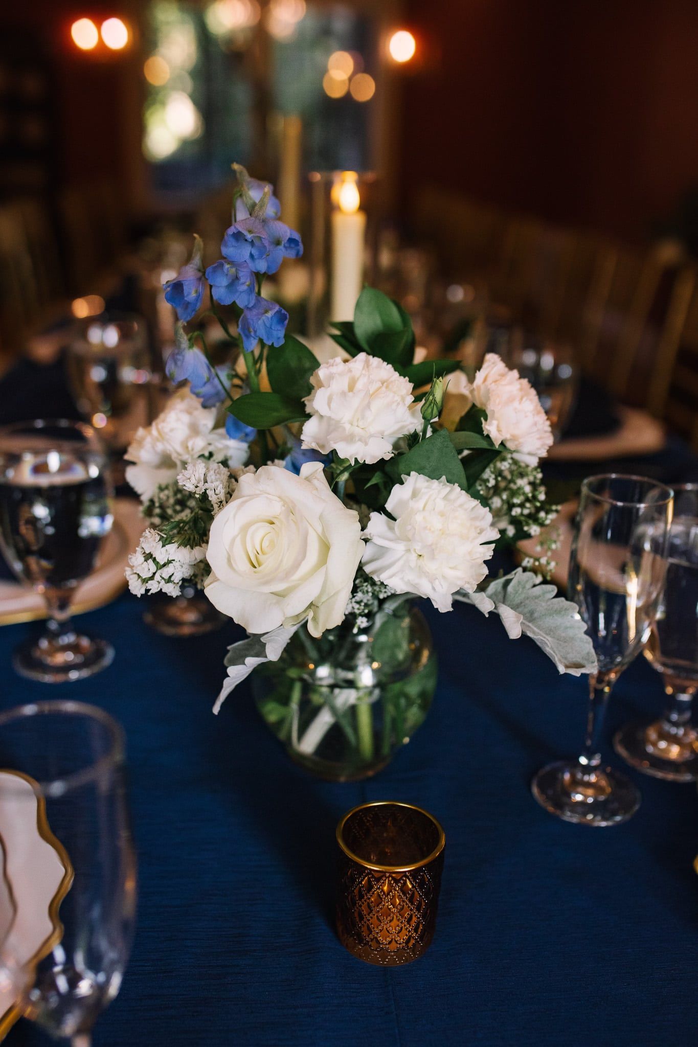 A vase filled with white flowers is sitting on a table.