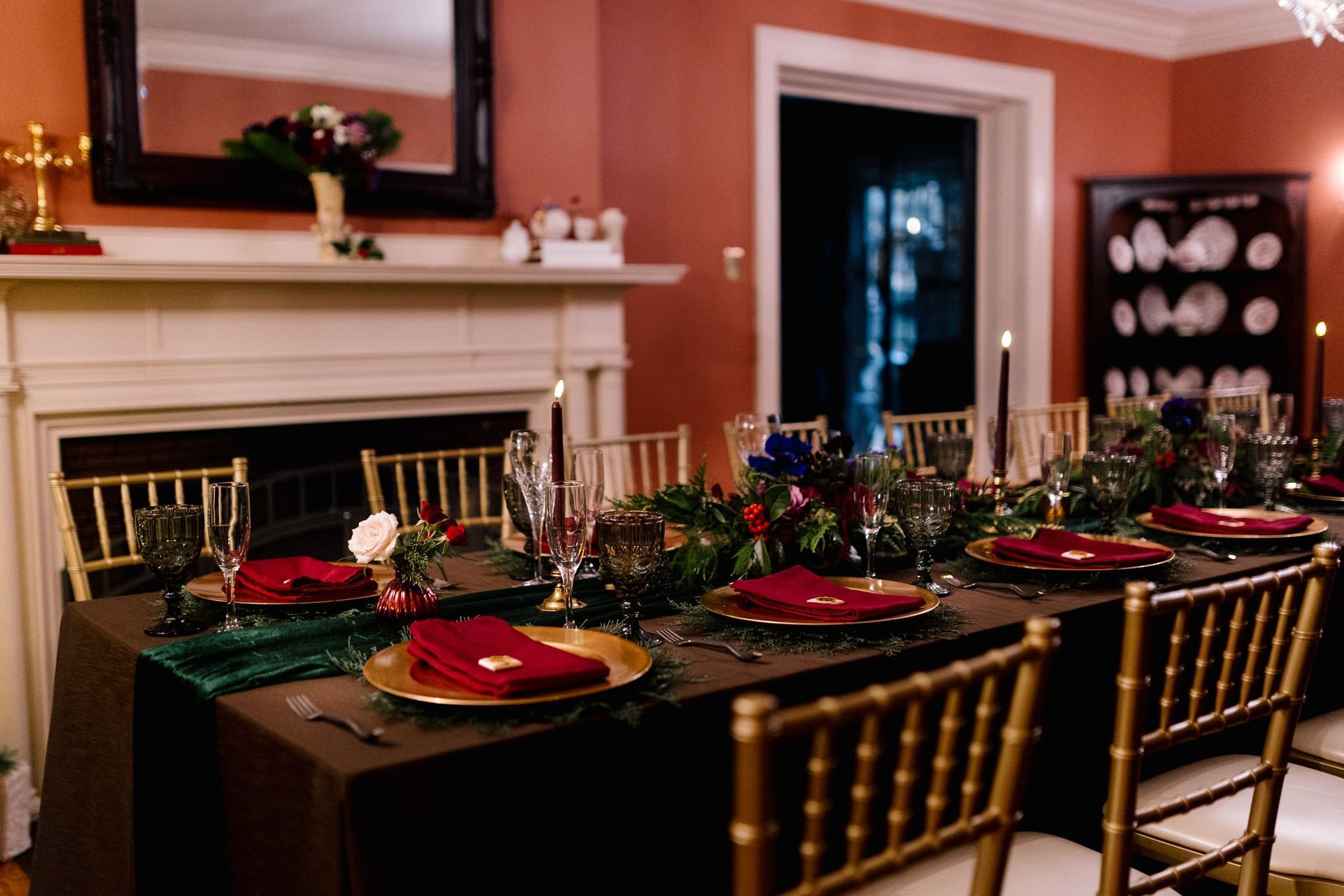 A dining room table with plates , glasses , and napkins on it.