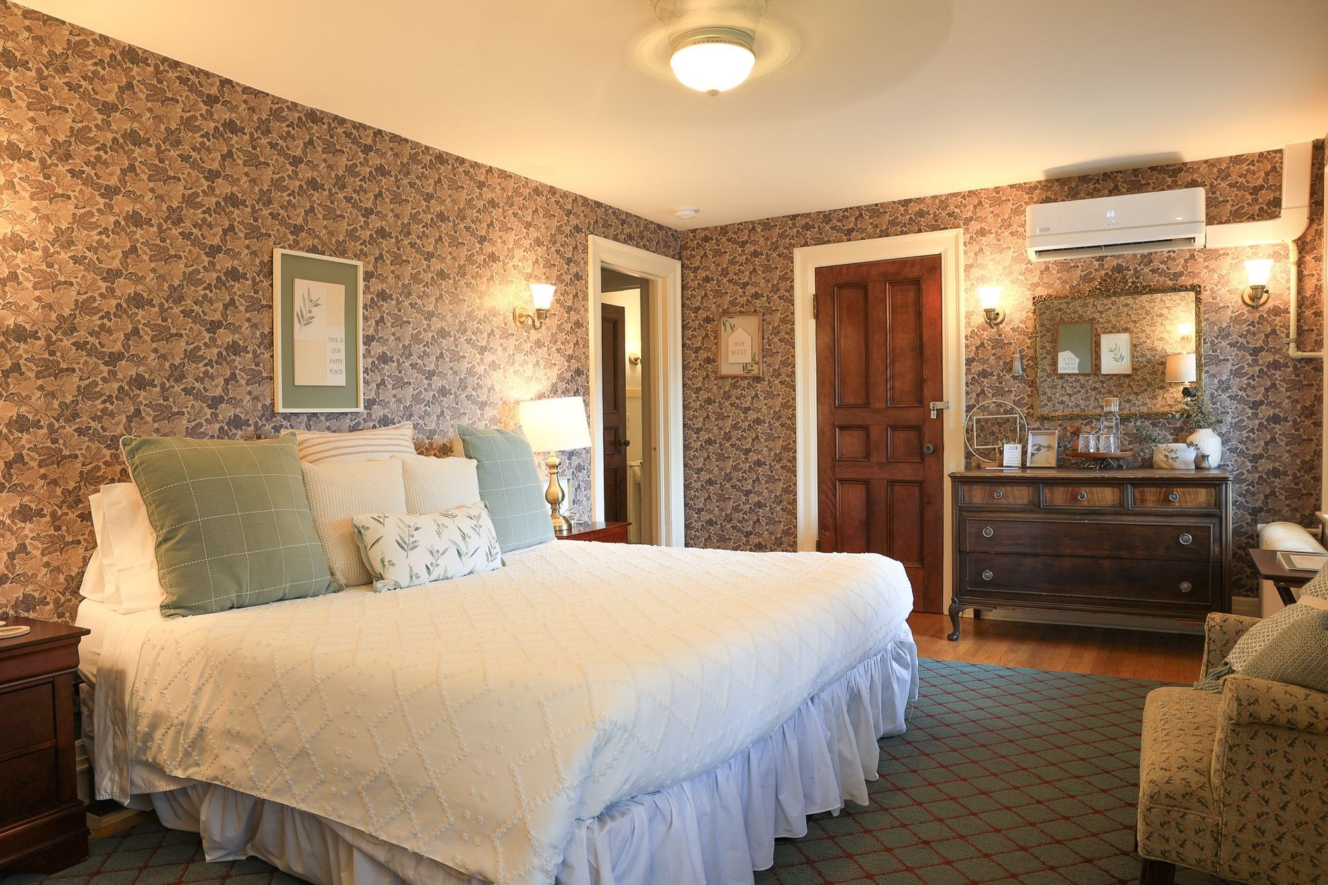 A bedroom with a large bed and a dresser