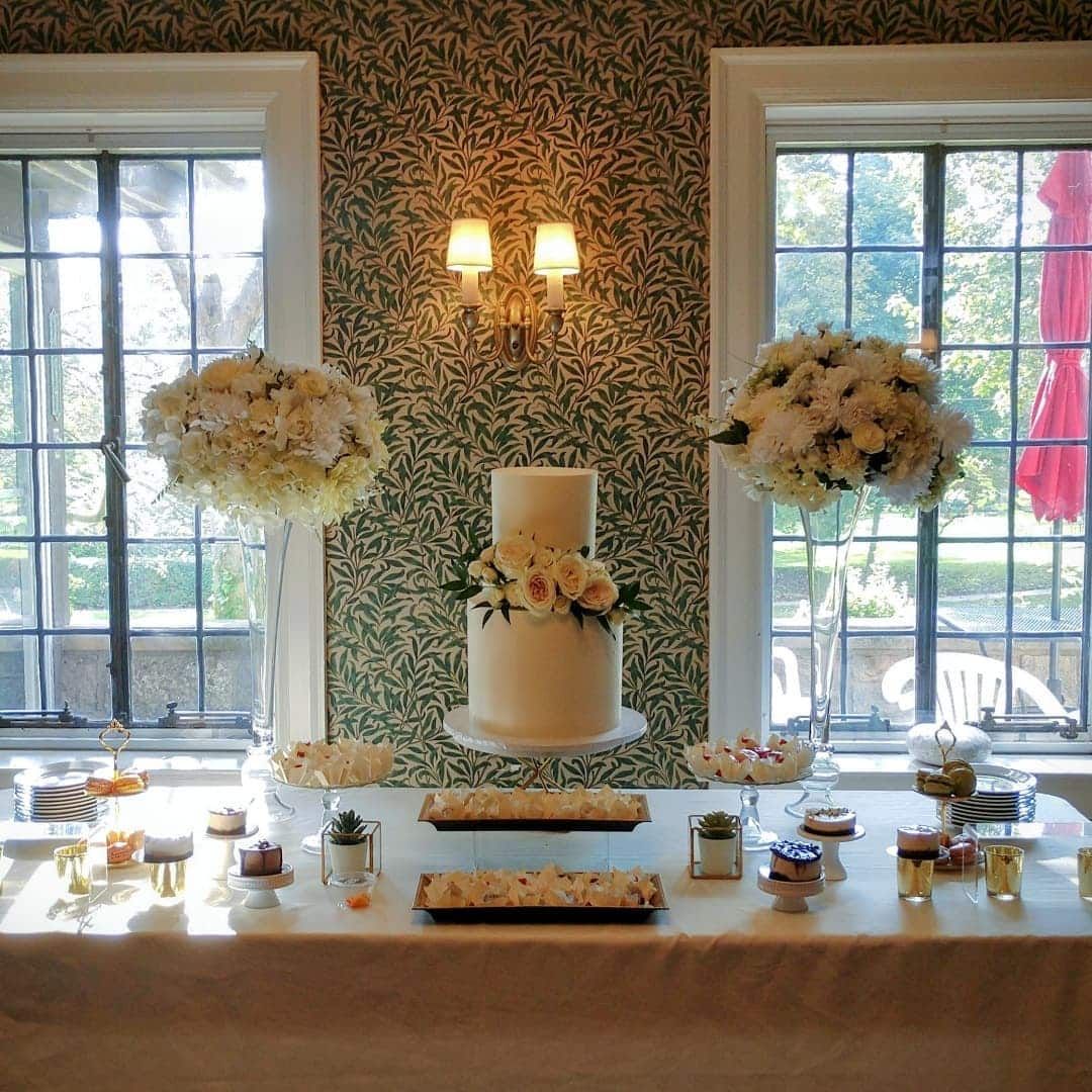 A table with a cake and flowers on it