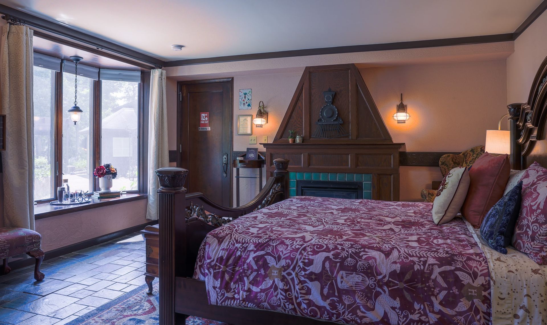 A bedroom with a large bed and a fireplace.