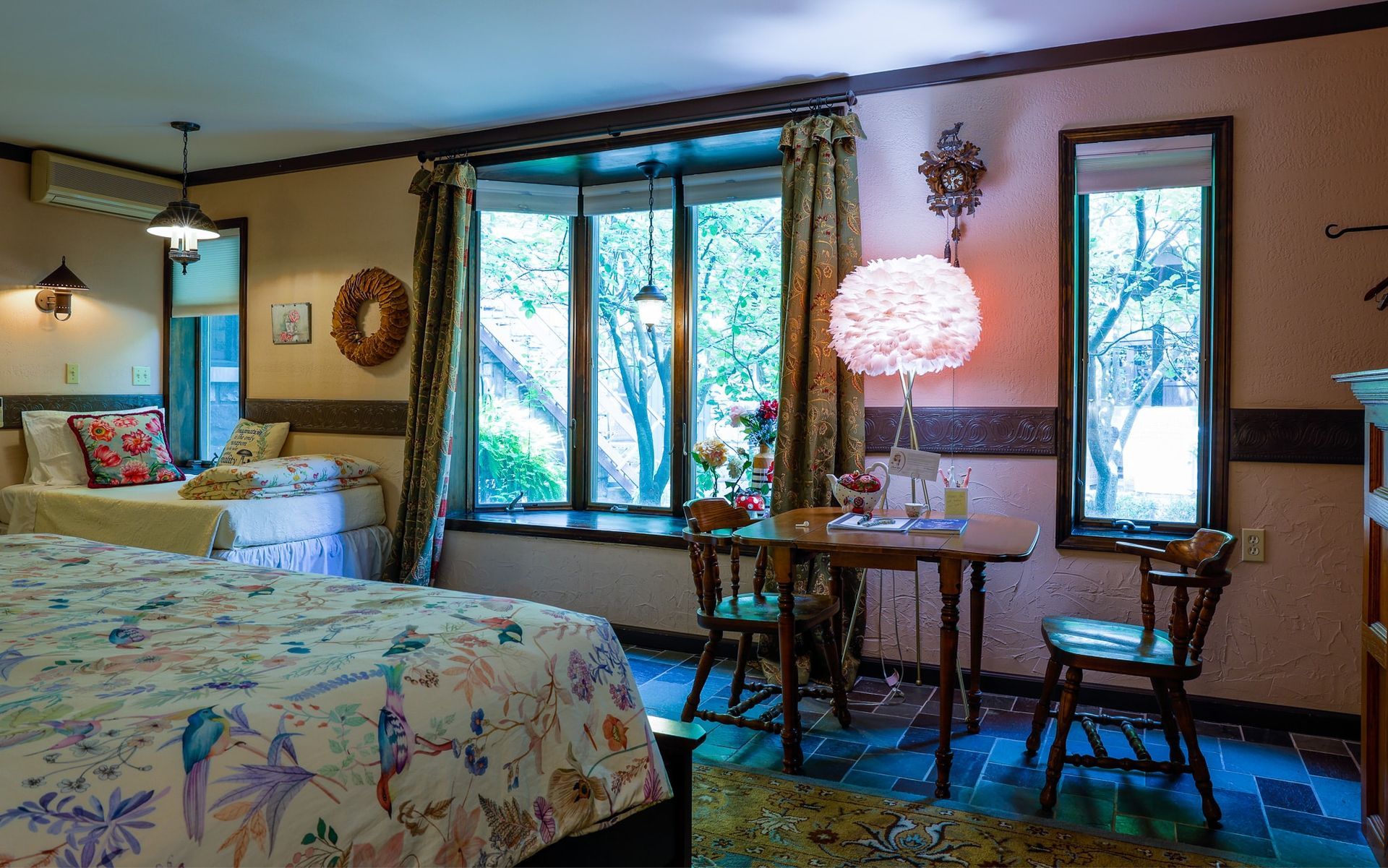 A hotel room with two beds , a table and chairs.
