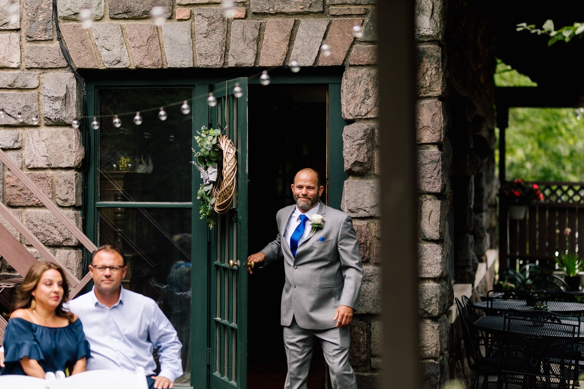 A man in a suit and tie is standing in the doorway of a building.