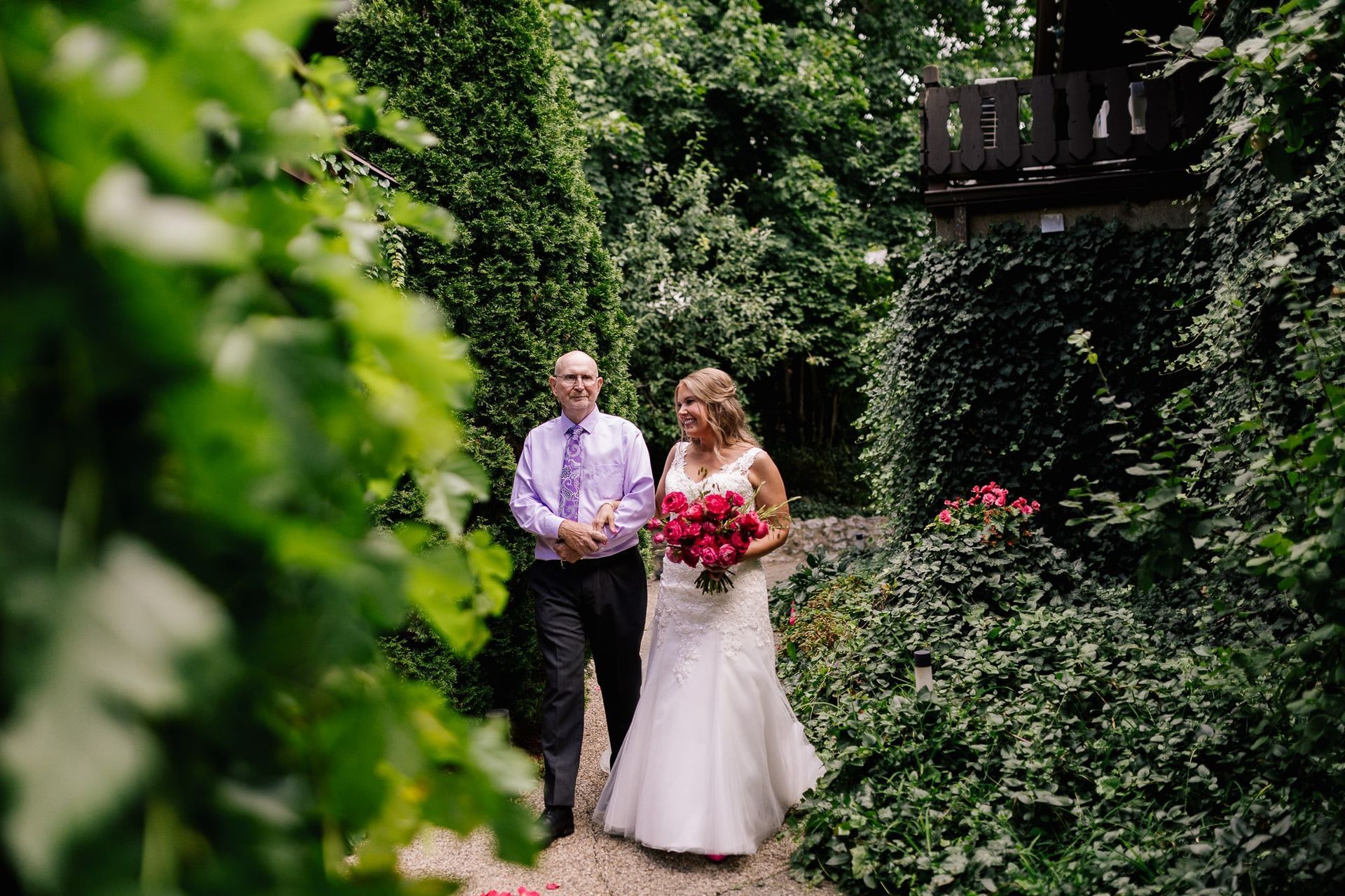 A bride and groom are walking down the aisle at their wedding.