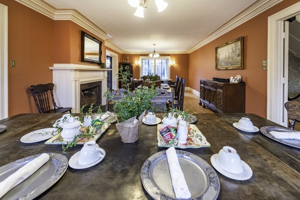 A dining room table with plates and cups on it