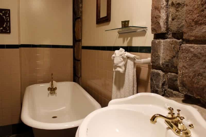 A bathroom with a claw foot tub and a sink