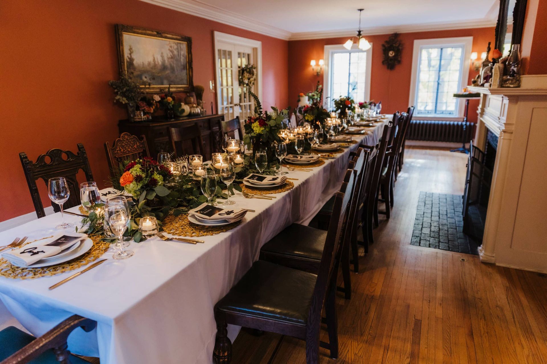 A long table is set for a dinner party in a dining room.