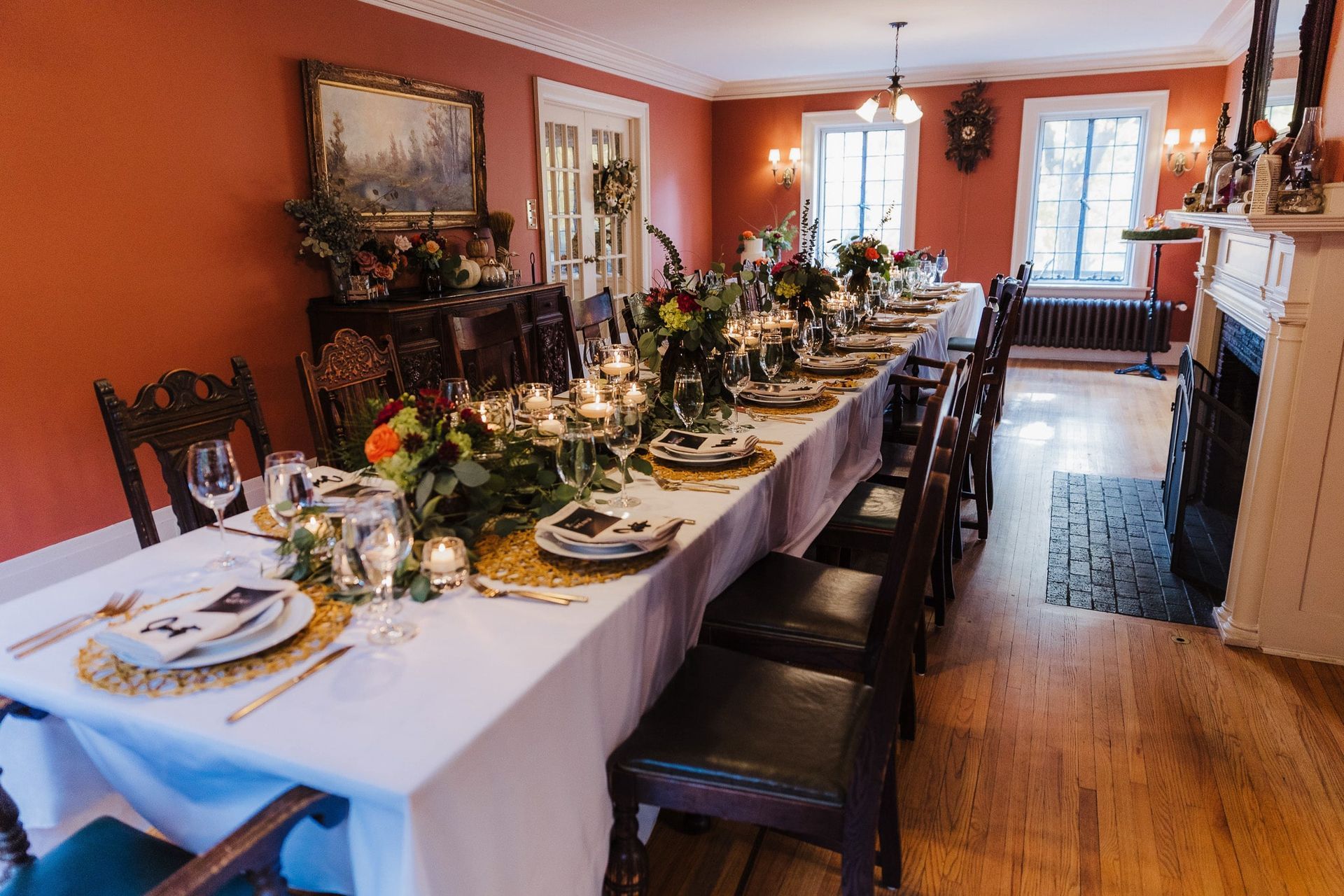 A long table is set for a dinner party in a dining room.