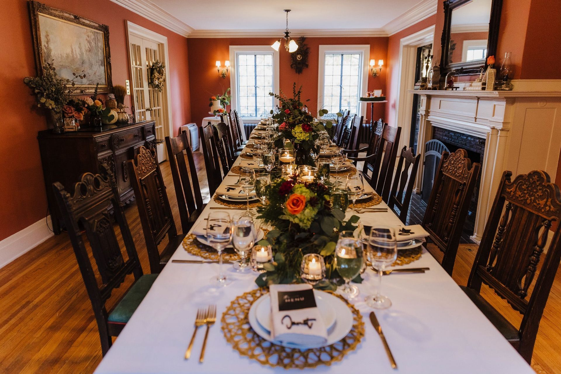 A long table is set for a dinner party in a dining room.