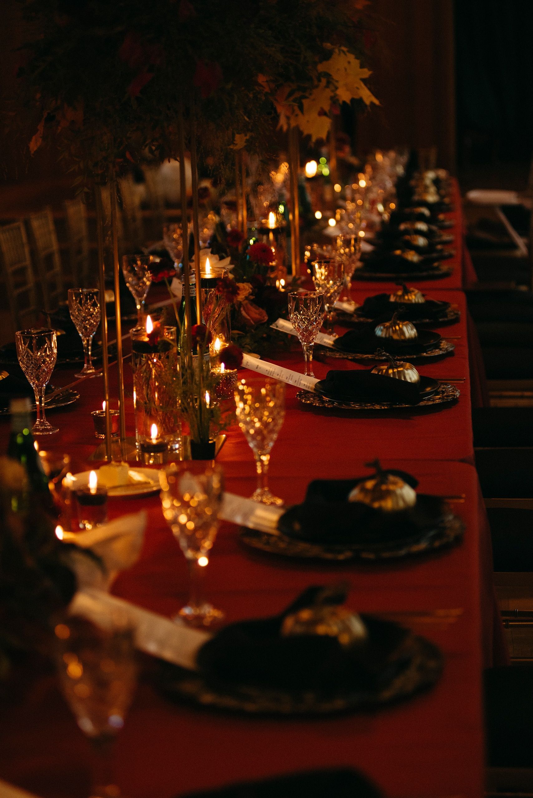 A long table with plates and candles on it