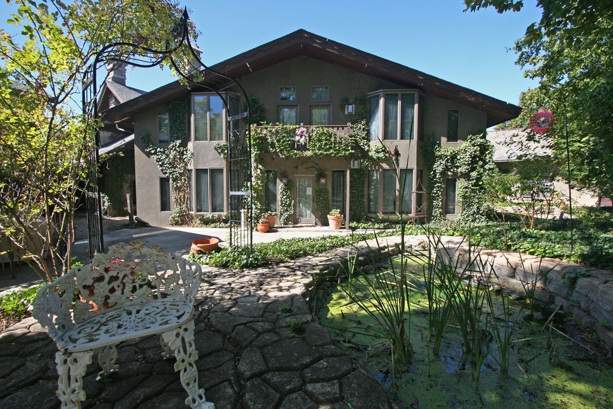 A large house with a bench in front of it