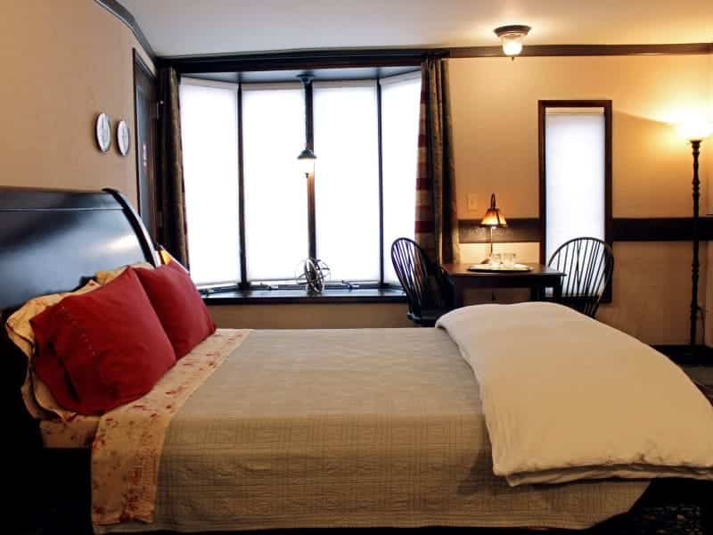 A bedroom with a large bed and a large window