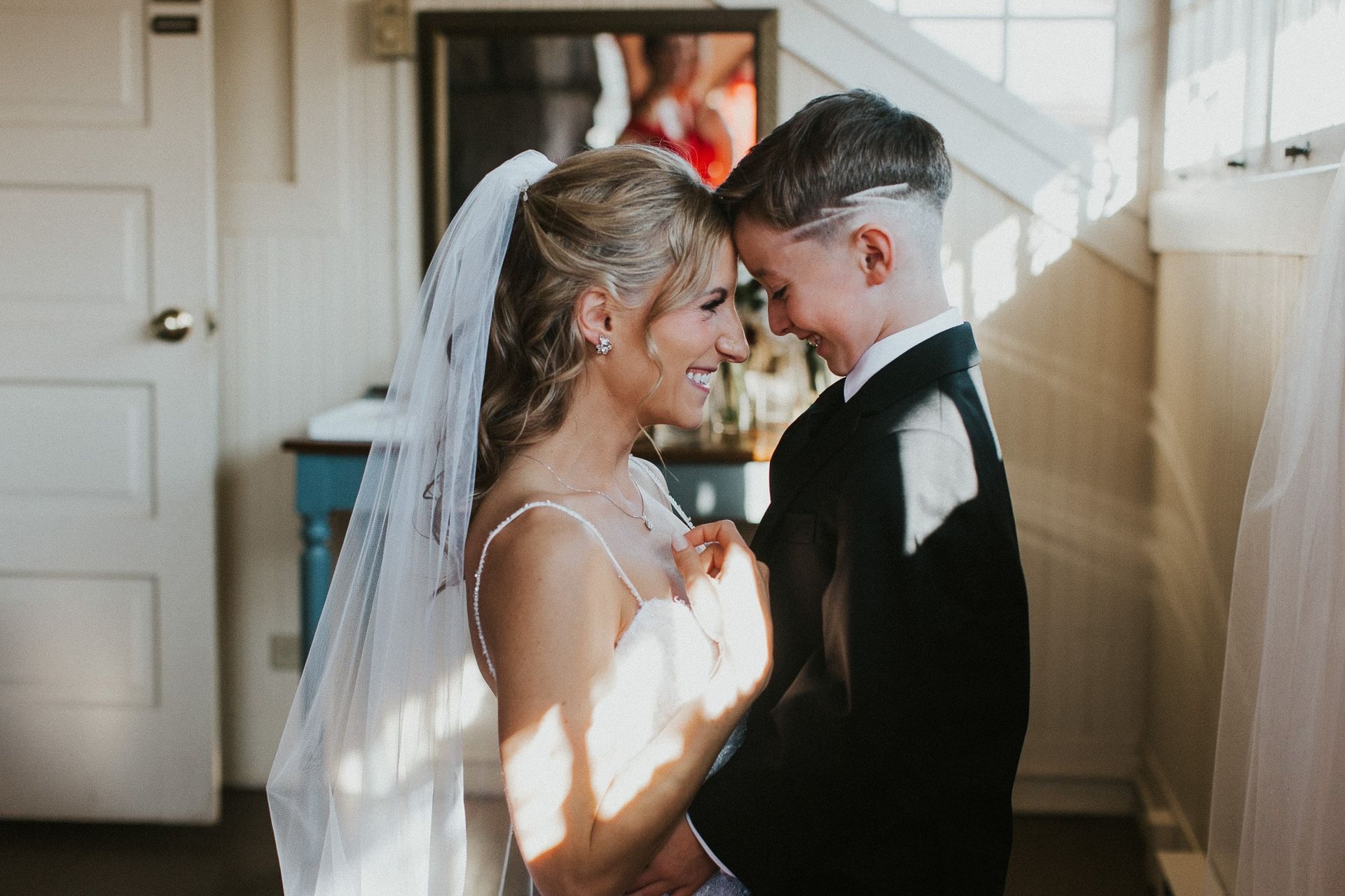 A bride and groom are dancing together in a room.
