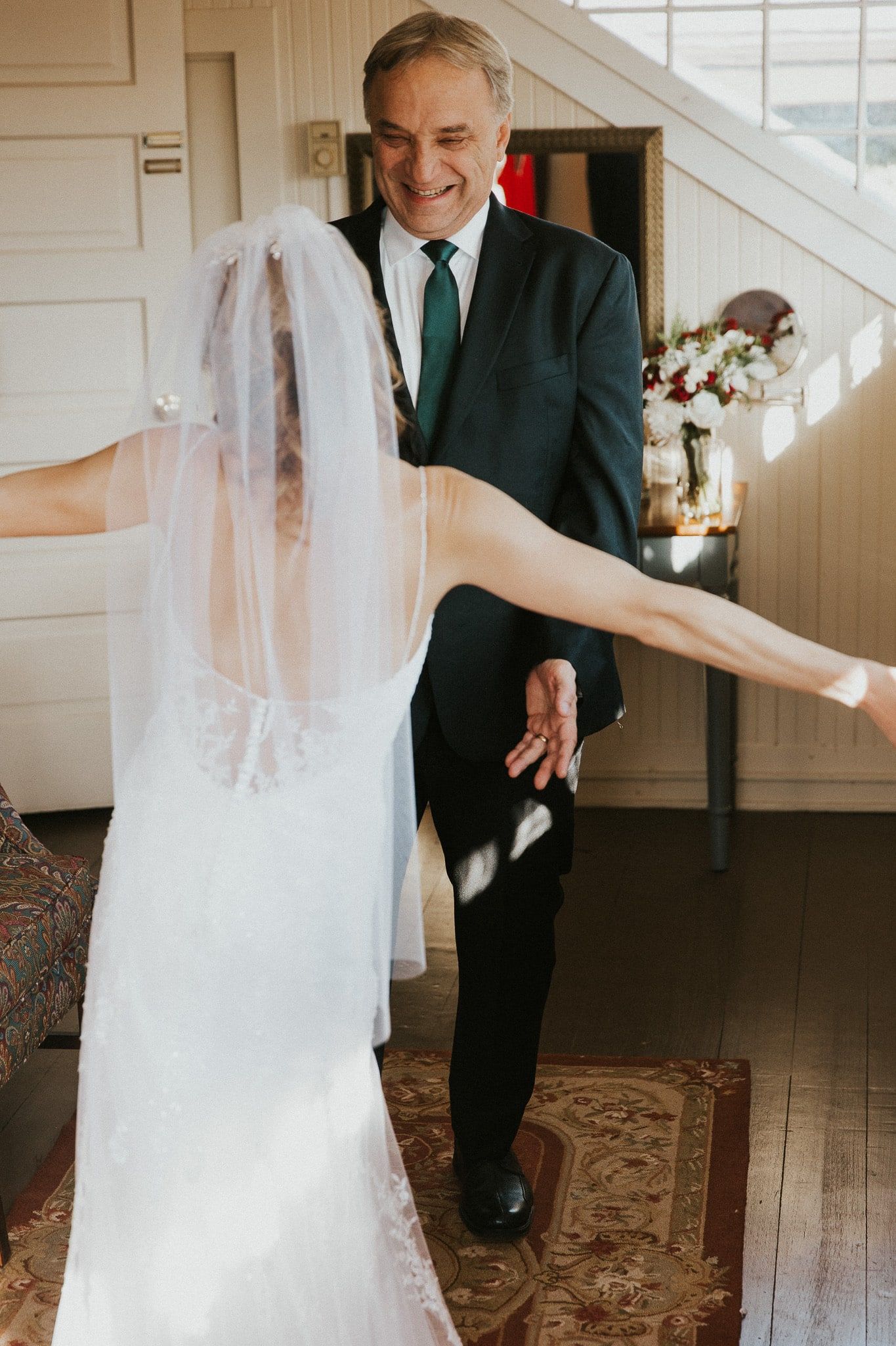 A man in a suit and tie is standing next to a woman in a wedding dress.