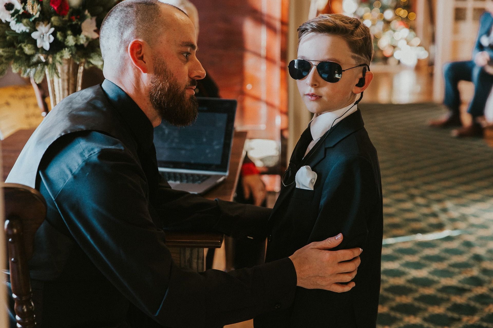 A man and a boy wearing sunglasses are standing next to each other.