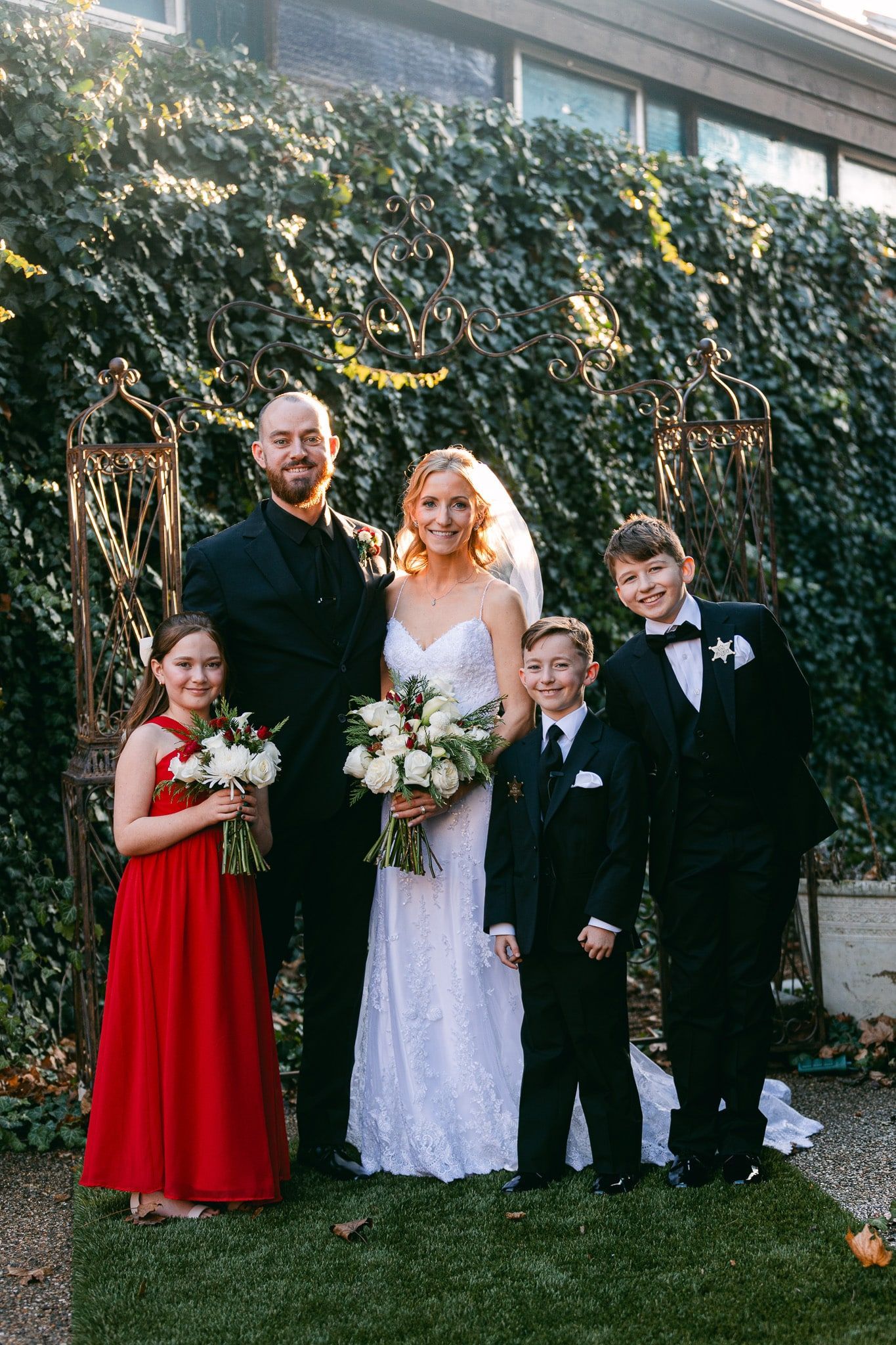 A bride and groom are posing for a picture with their wedding party.