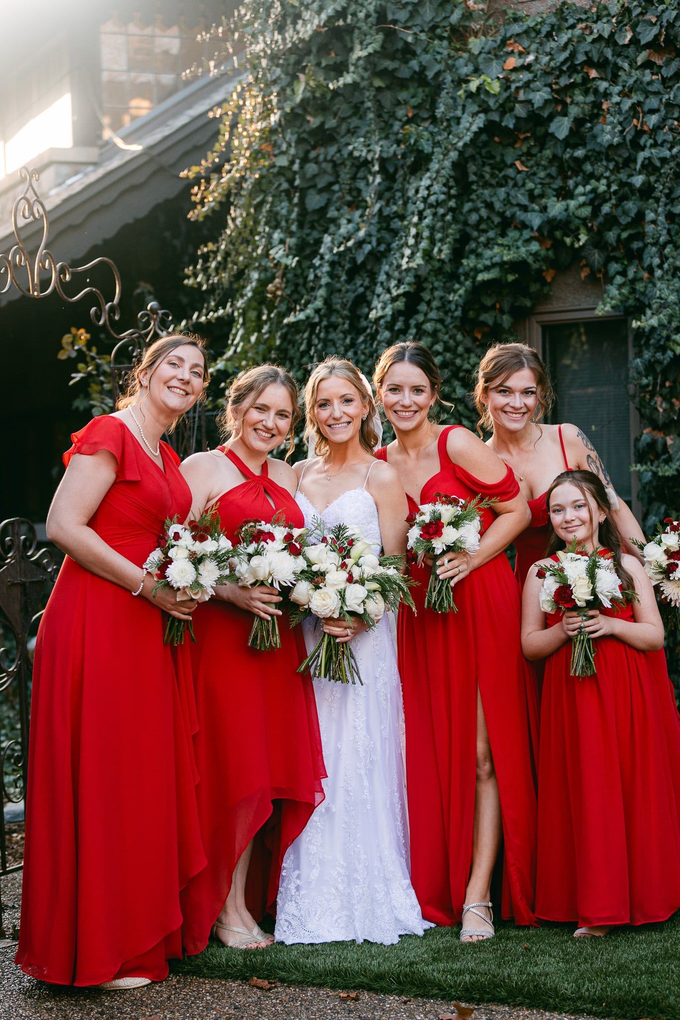 A bride and her bridesmaids are posing for a picture in front of a building.