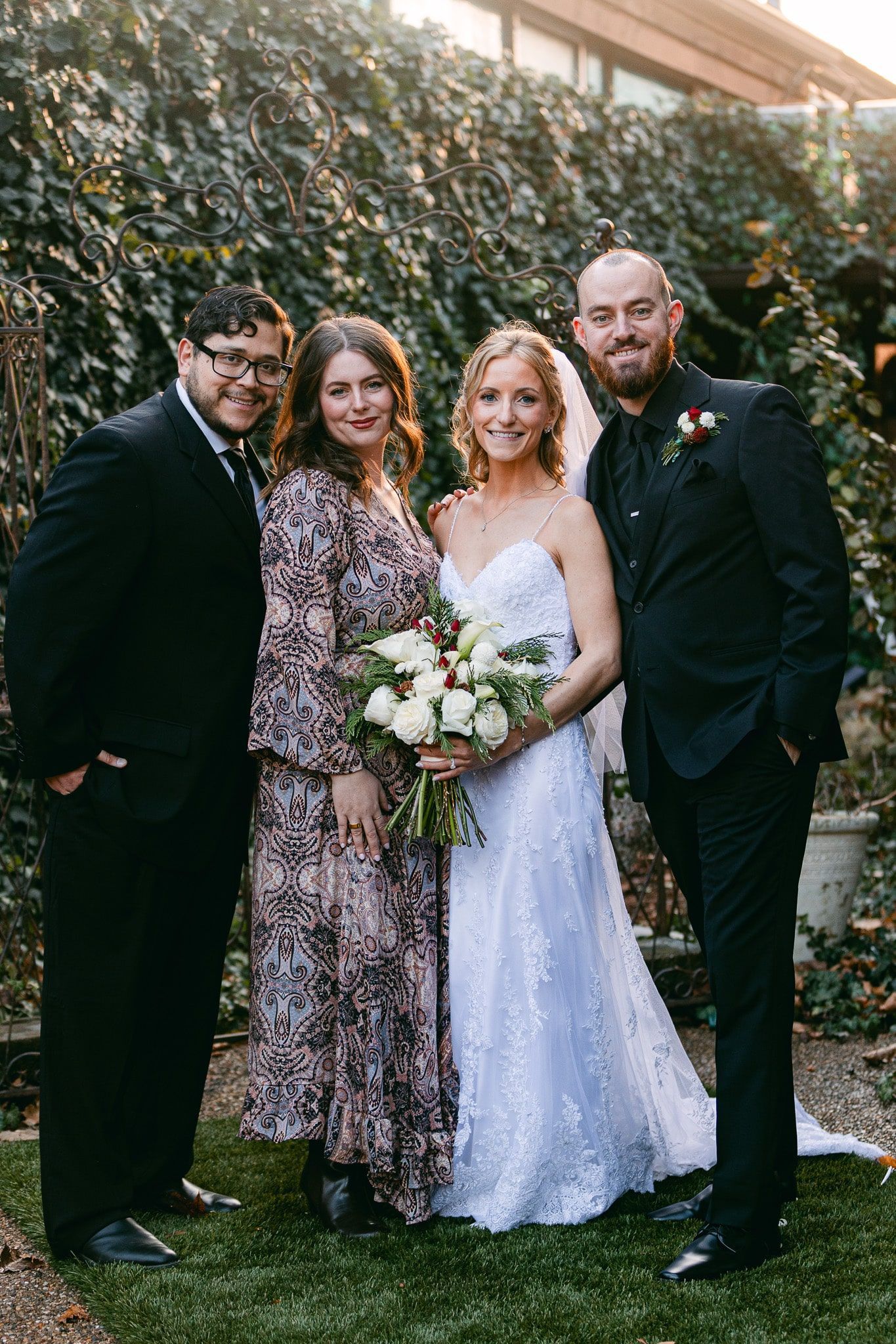 A bride and groom are posing for a picture with their wedding party.