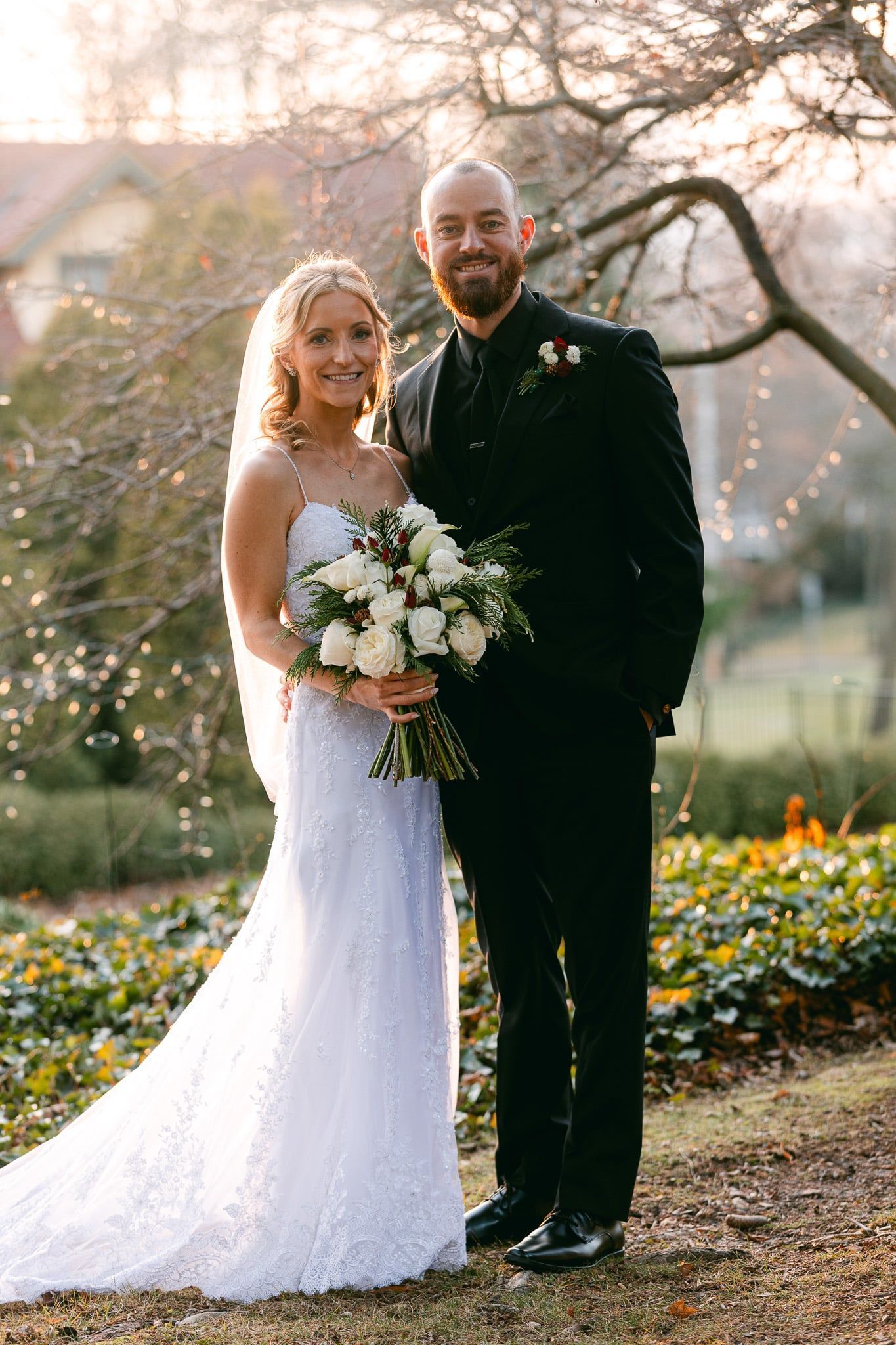 A bride and groom are posing for a picture in a park.