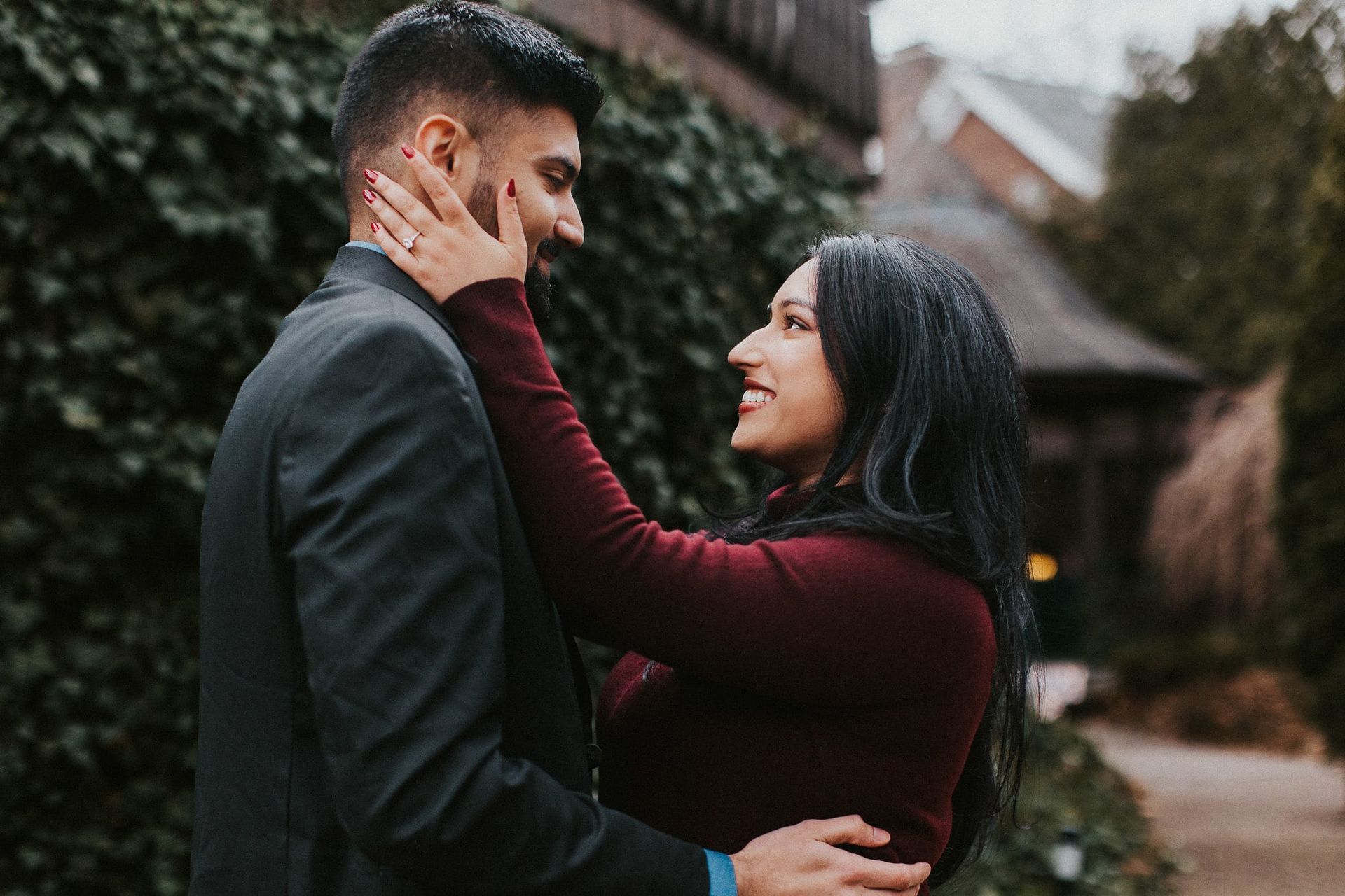 A man and a woman are hugging each other and looking at each other.