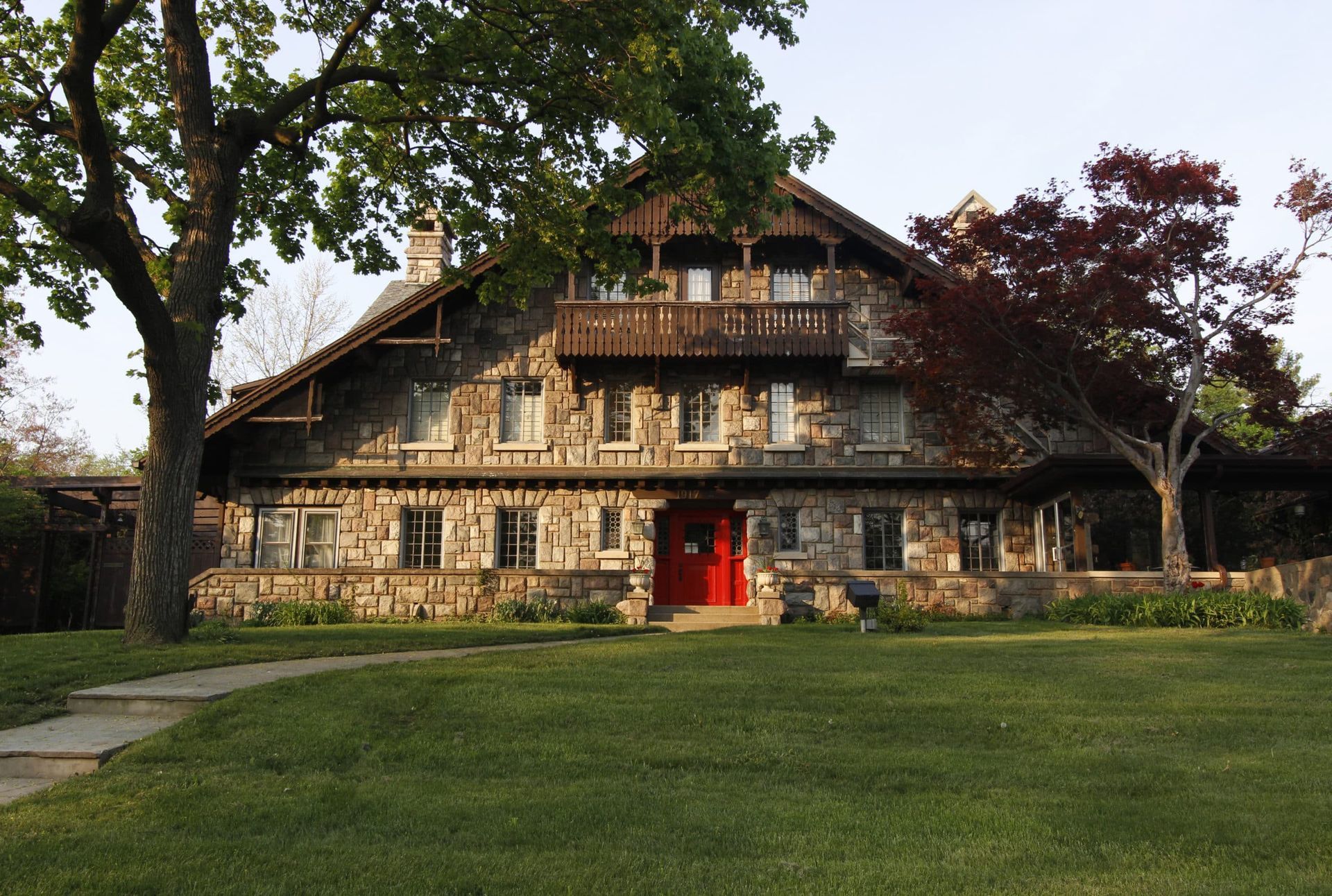 A large stone house with a red door