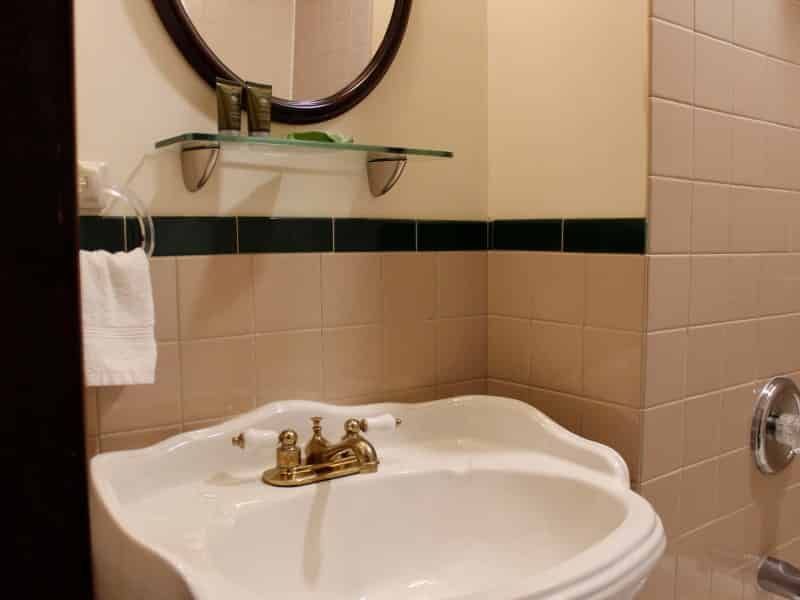 A bathroom with a sink and a mirror on the wall
