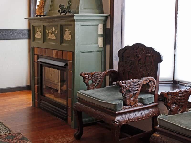 A chair in front of a fireplace in a living room