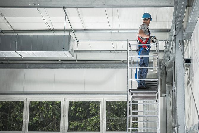 worker on scaffolding wearing safety helmet