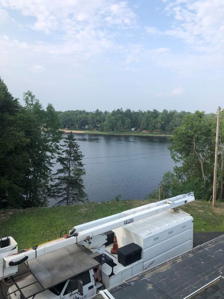 A white truck is parked in front of a lake.