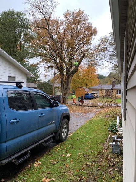 A blue truck is parked in front of a house.