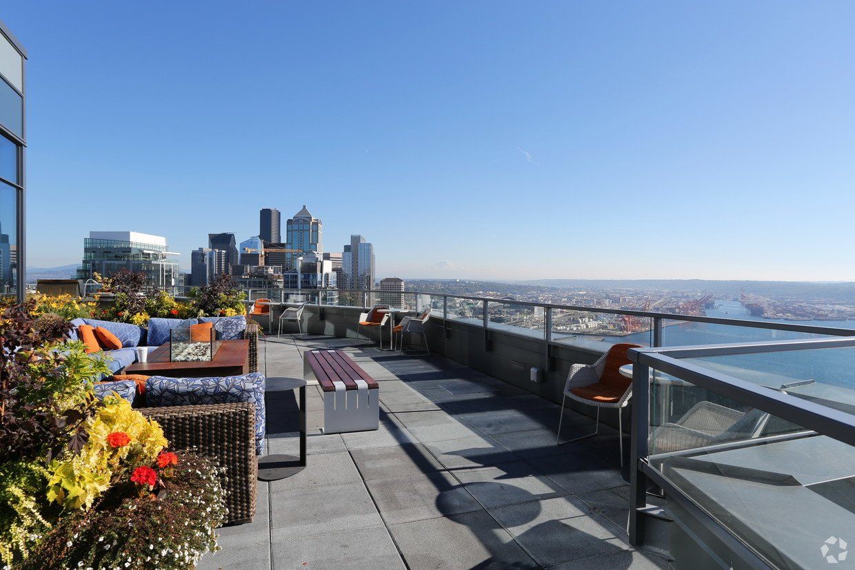 A rooftop terrace with a view of the city skyline