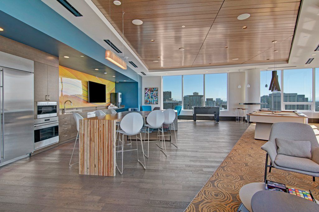 A large room with a table and chairs in it at Tower12 Apartments.