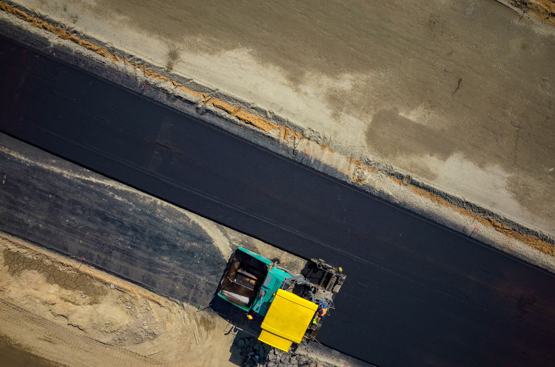 An aerial view of a truck driving down a road.